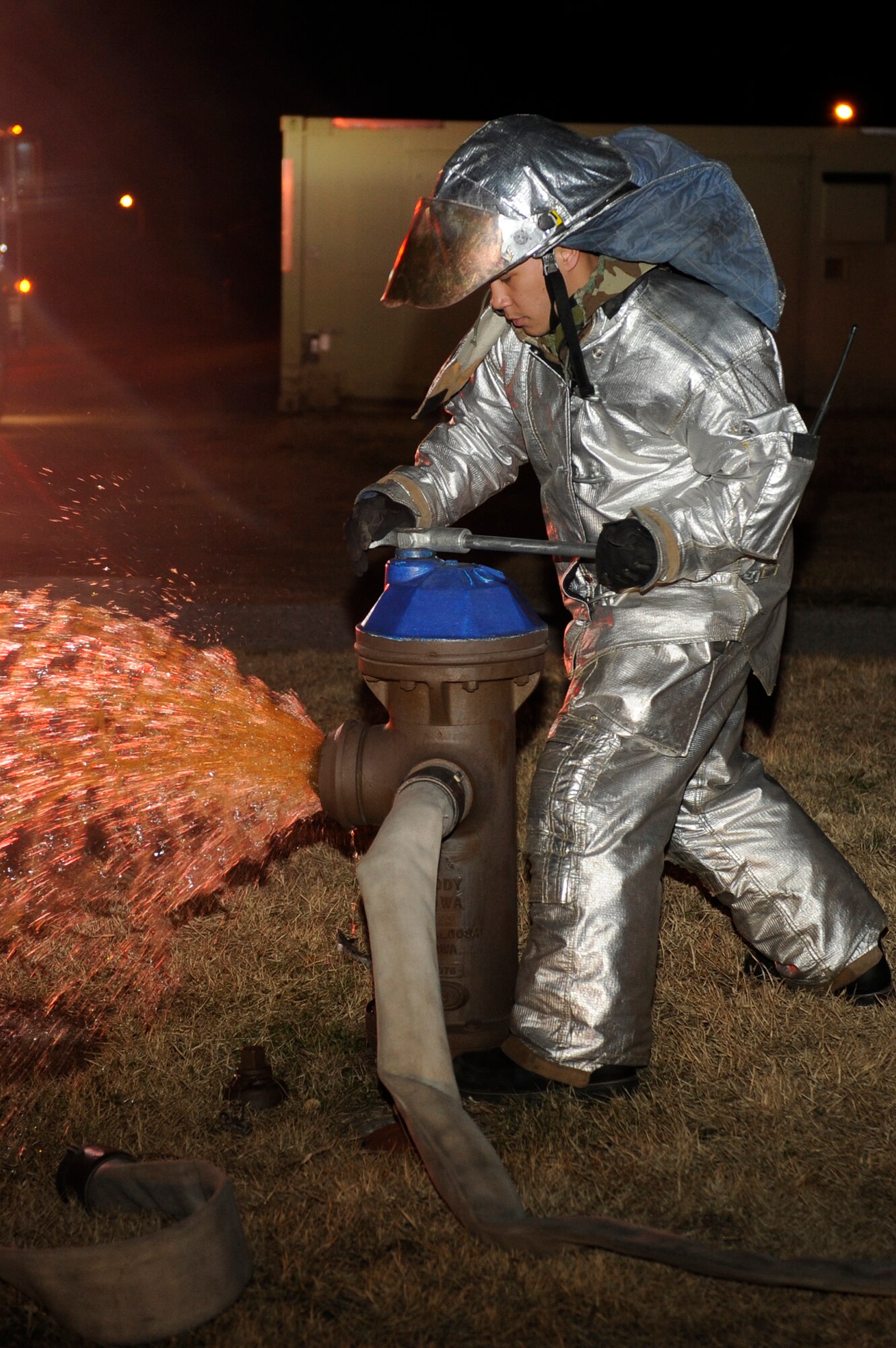 KUNSAN AIR BASE, Republic of Korea -- Senior Airman Christopher Reyes, 8th Civil Engineer Squadron firefighter, opens a fire hydrant during exercise Beverly Midnight 13-2 at Kunsan Air Base, Republic of Korea, March 21, 2013. The scenario included  Reyes and other firefighters responding to a simulated gas fire caused by a mortar attack. (U.S. Air Force photo by Senior Airman Marcus Morris/Released)