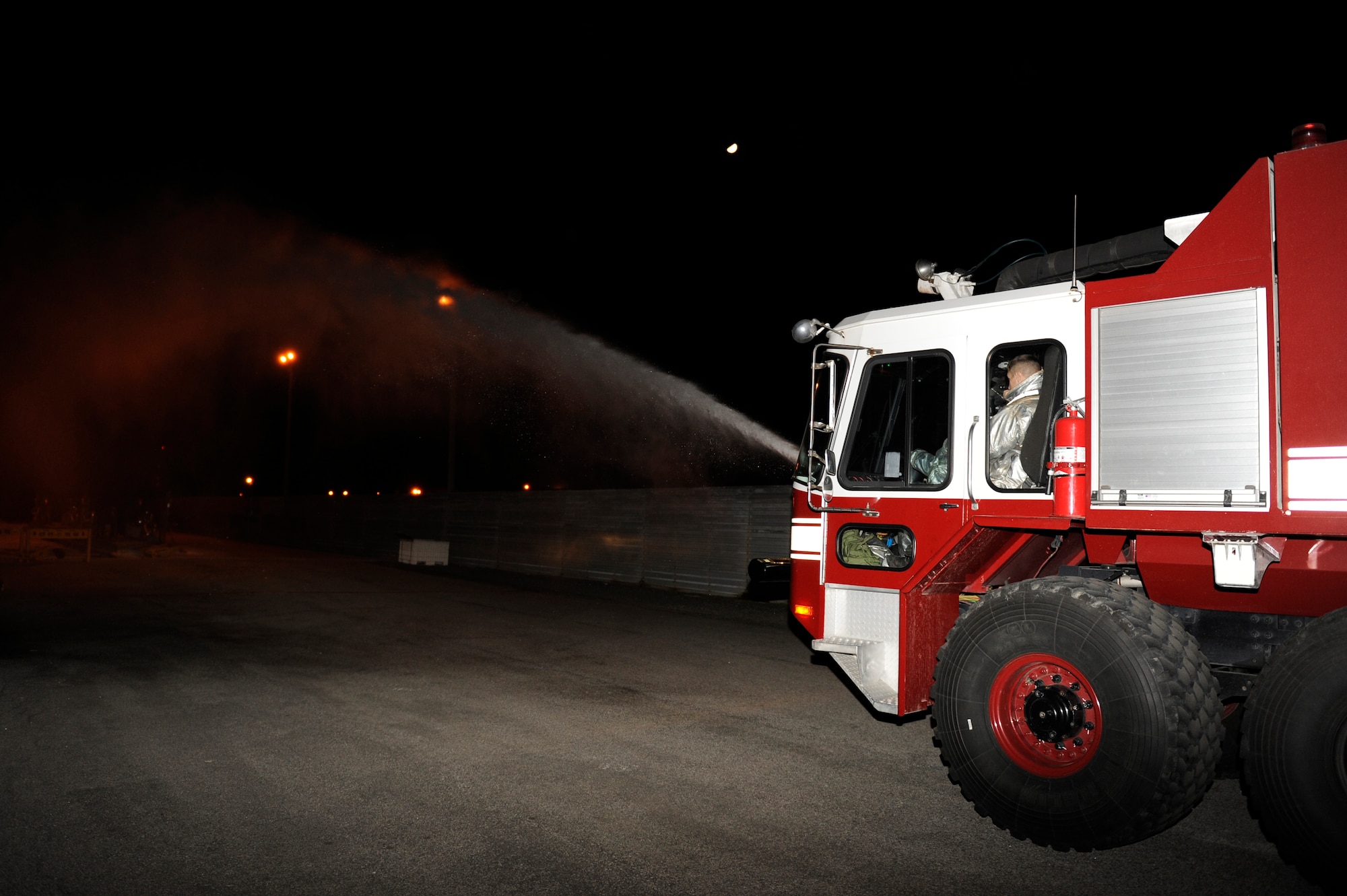KUNSAN AIR BASE, Republic of Korea -- Firefighters from the 8th Civil Engineer Squadron fight a simulated gas fire during exercise Beverly Midnight 13-2 at Kunsan Air Base, Republic of Korea, March 21, 2013. The firefighters doused the area in water to extinguish the flames. (U.S. Air Force photo by Senior Airman Marcus Morris/Released)