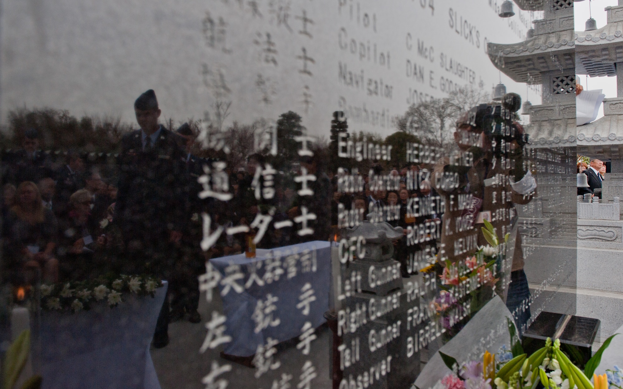 GUNMA PREFECTURE, Japan -- A memorial monument in honor of fallen B-29 aircrews reflects Airmen from Yokota Air Base, Japan, and Japanese citizens during an unveiling ceremony March 20, 2013, at Gunma Prefecture, Japan. Since 1972, Yokota Airmen have participated in joint ceremonies with Japanese citizens throughout the region to honor fallen B-29 aircrews. This was the first ceremony taken place in Gunma. (U.S. Air Force photo by Senior Airman Cody H. Ramirez)