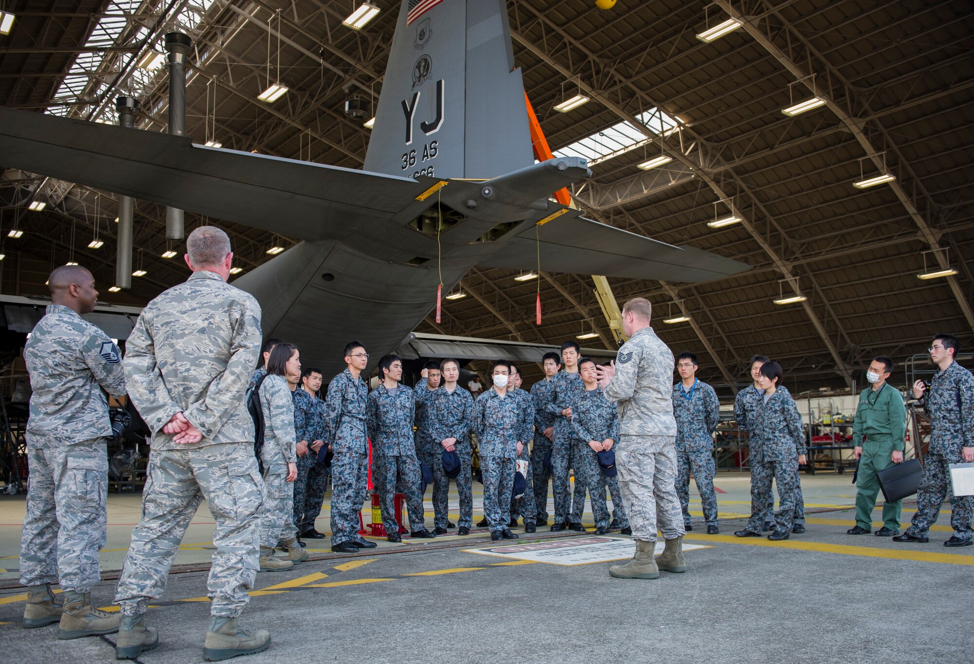 YOKOTA AIR BASE, Japan -- Staff Sgt. John Lyon, 374th Maintenance Squadron transient alert section chief, briefs JASDF officer cadets about the important role transient alert has during an aircraft maintenance tour at Yokota Air Base, Japan, March 19, 2013. The cadets toured several maintenance facilities and had an opportunity to practice their English skills, while learning about Yokota's maintenance and airlift capabilities. (U.S. Air Force photo by Senior Airman Andrea Salazar)