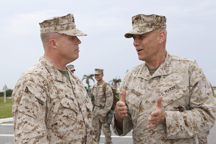 Gen. John M. Paxton Jr., assistant commandant of the Marine Corps, right, speaks with Chief Warrant Officer Derek G. Williams on Camp Kinser, Okinawa, Japan, March 18. During his visit to Okinawa March 17-20, Paxton talked with Marines and sailors about the importance of the Marine Corps' presence in the Asia-Pacific region. Williams is the chemical, biological, radiological and nuclear defense officer in charge for S-3 operations and training, Headquarters Company, Combat Logistics Regiment 37, 3rd Marine Logistics Group, III Marine Expeditionary Force. 