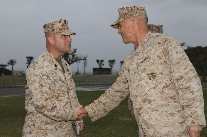 Gen. John M. Paxton Jr., assistant commandant of the Marine Corps, right, shakes hands with Command Master Chief Petty Officer Eric S. Anderson on Camp Kinser, Okinawa, Japan, March 18. During his visit to Okinawa March 17-20, Paxton talked with Marines and sailors about the importance of the Marine Corps' presence in the Asia-Pacific region. Anderson is the command master chief of 3rd Marine Logistics Group, III Marine Expeditionary Force. 