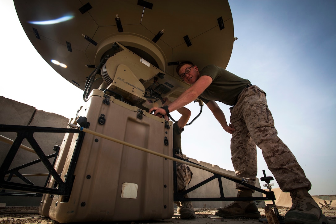 U.S. Marine Lance Cpls, Nickolas Franklin and Zachary Schiable, both data network specialists from Richmond CA., and Corona CA., respectively and assigned to Headquarters Company, Regimental Combat Team 7, conduct an operations check on a Secure internet protocol and Non-secure Internet Protocol Router Access Point (SNAP) satellite communications system on Camp Leatherneck, Helmand Province, Afghanistan, March 18, 2013.  The Marines were ensuring that the SNAP system worked properly before shipping it off to Forward Operating Base Kajaki. (U.S. Marine Corps photo by Staff Sgt. Ezekiel R. Kitandwe/Released)