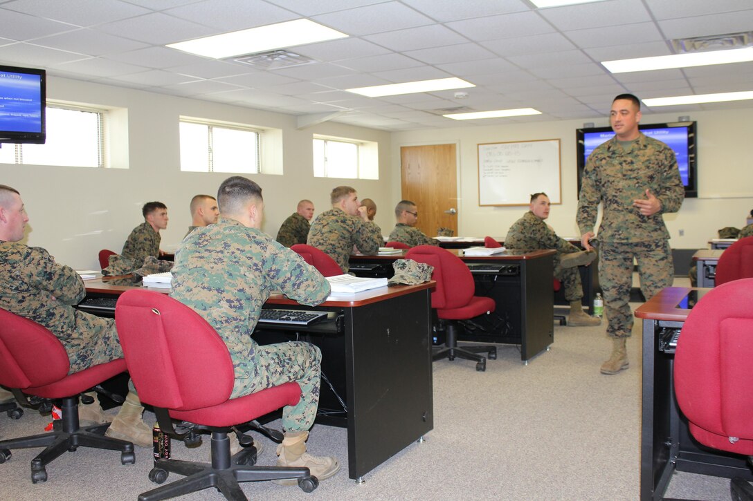 Staff Sergeant John Herrera presents instruction on United States Marine Corps uniform regulations to Corporals Course students. 