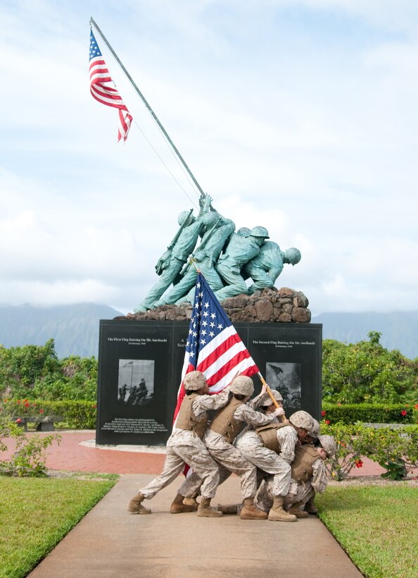 MARINE CORPS BASE HAWAII - To pay tribute to America’s women Marines, Marine Corps Base Hawaii asked six women from the base to participate in a re-enactment of the raising of the flag at the Battle of Iwo Jima in World War II. Five Marines and one Navy corpsman support the flag in front of the Pacific War Memorial at MCB Hawaii. (U.S. Marine Corps photo by Kristen Wong)