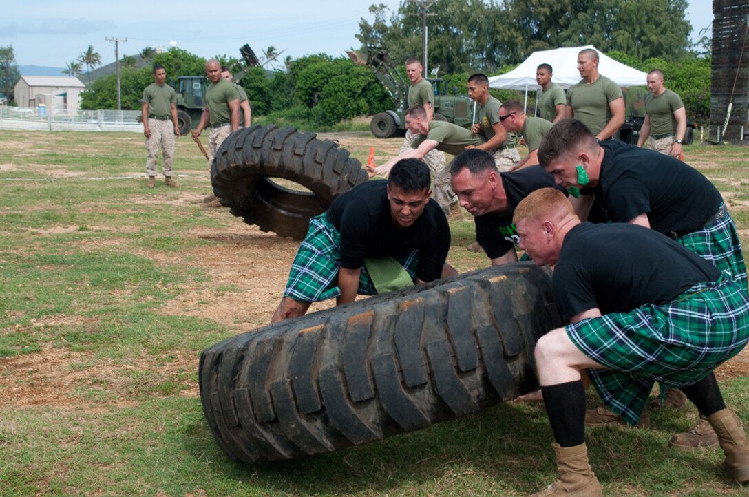 MARINE CORPS BASE HAWAII - Teams of combat engineers work together to flip a heavy tire in Combat Logistics Battalion 3’s inaugural Engineer’s Day at Landing Zone Boondocker, March 15, 2013. In addition to traditional Highland games, members of CLB-3’s Engineers Services Company participated in Marine Corps challenges including a weapons relay and fireman’s carry. (U.S. Marine Corps photo by Christine Cabalo)