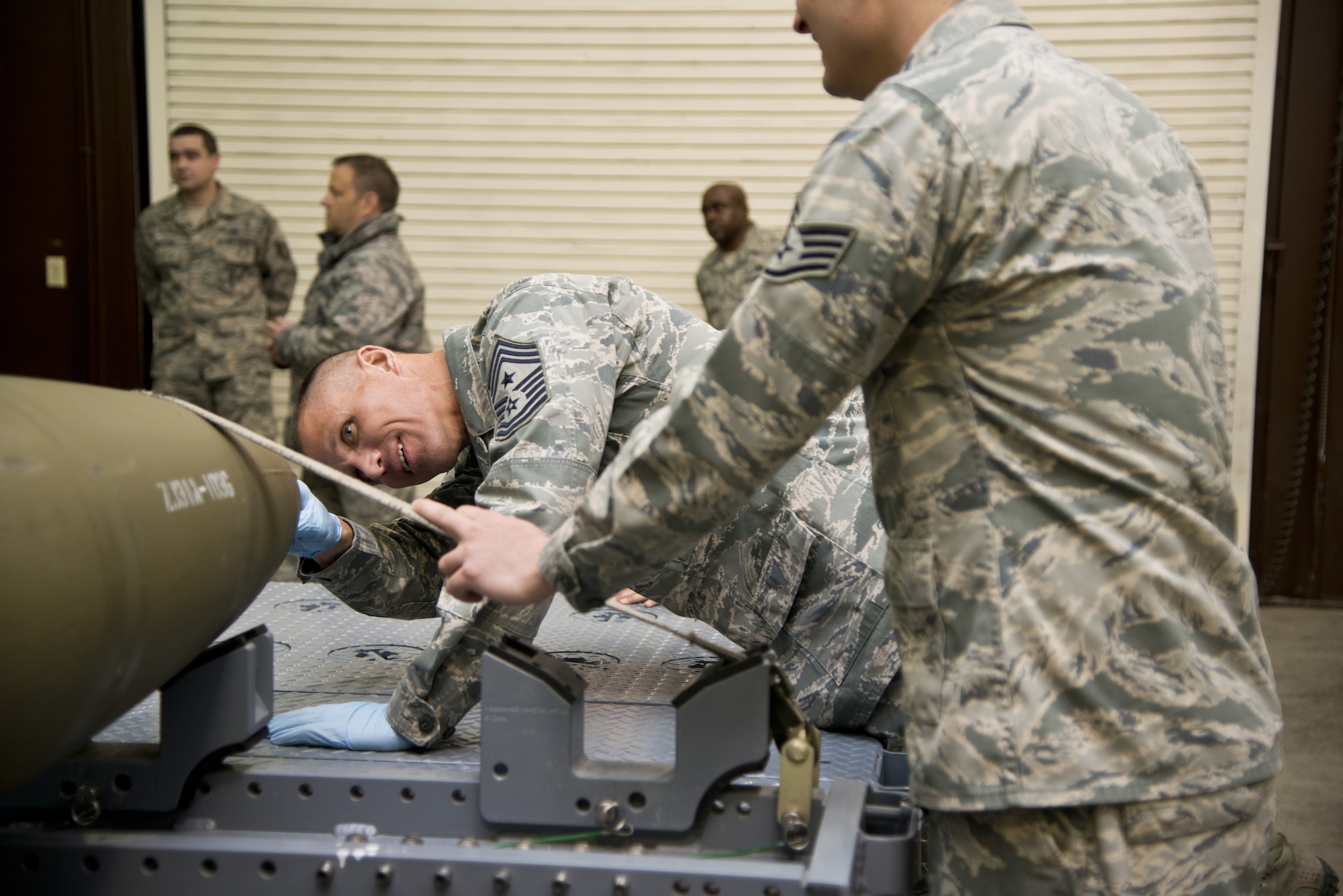 JOINT BASE ELMENDORF-RICHARDSON, Alaska -- Chief McDonald, Pacific Air Forces command chief, peers at the inside of an innate bomb during a bomb build process on Joint Base Elmendorf-Richardson, Alaska, March 18, 2013. The 3d Munitions Squadron demonstration was to show the chief how to process a bomb build. (U.S. Air Force photo/Airman 1st Class Omari Bernard/Released)
