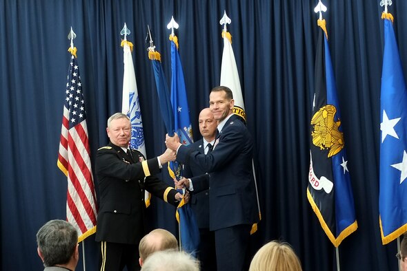Air Force Lt. Gen. Stanley Clarke III, right, the director of the Air National Guard, receives the organizational colors of the Air National Guard from Army Gen. Frank Grass, chief, National Guard Bureau, during a ceremony at the Air National Guard Readiness Center at Joint Base Andrews, Md., where Clarke assumed the responsibilities of his current position, Friday, March 22, 2013. Clarke takes over the duties of director from Air Force Lt. Gen. Harry "Bud" Wyatt, who retired. (U.S. Army photo by Sgt. 1st Class Jon Soucy)(Released)
