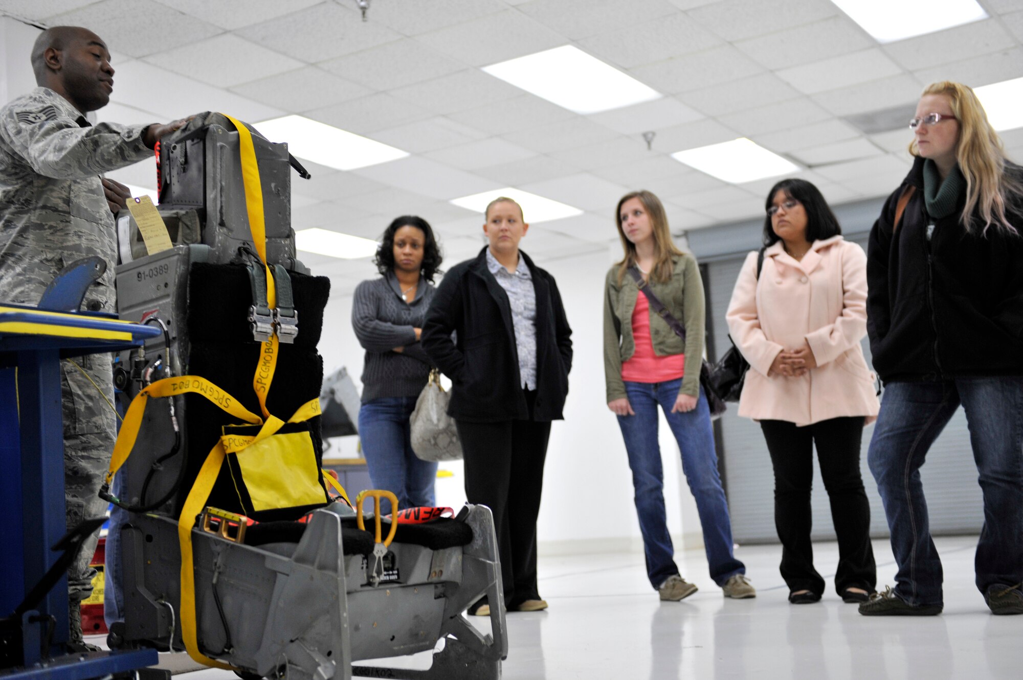 U.S. Air Force Staff Sgt. Sean Haynes, 20th Component Maintenance Squadron egress systems technician, explains to spouses from the 20th CMS about ejection seats used by pilots during an emergency, Shaw Air Force Base, S.C., March 22, 2013. The 20th CMS hosted the spouse’s tour for family members to see what their loved ones do on a daily basis. (U.S. Air Force photo by Senior Airman Amber E. N. Jacobs/Released)














