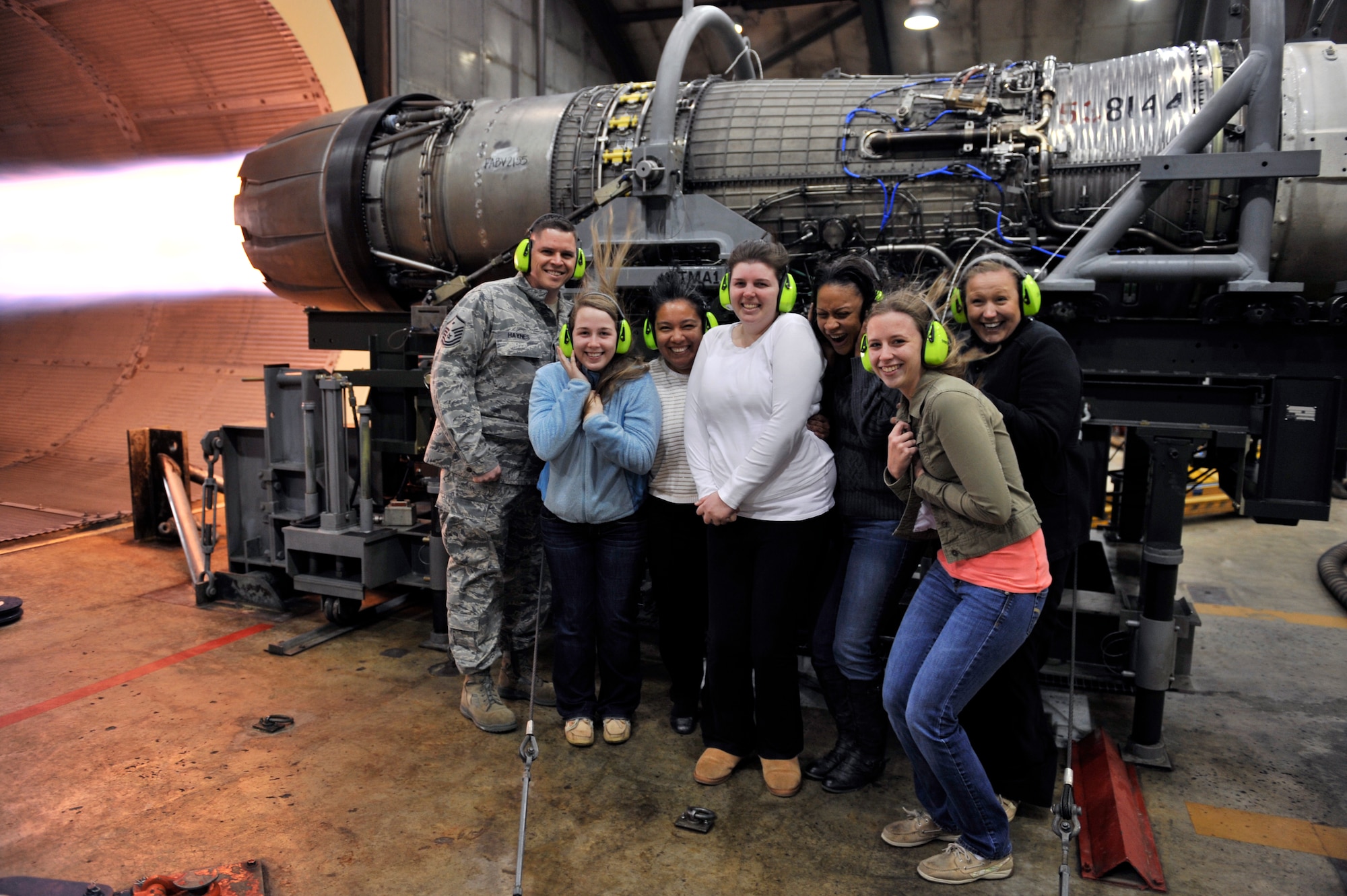 U.S. Air Force Master Sgt. David Haynes, 20th Component Maintenance Squadron first sergeant, and spouses from the 20th CMS stand next to an F-16 Fighting Falcon engine during a test fire, Shaw Air Force Base, S.C., March 22, 2013. Spouses from the 20th CMS visited the engine test facility, also known as the hush house, as part of a squadron tour. (U.S. Air Force photo by Senior Airman Amber E. N. Jacobs/Released)







