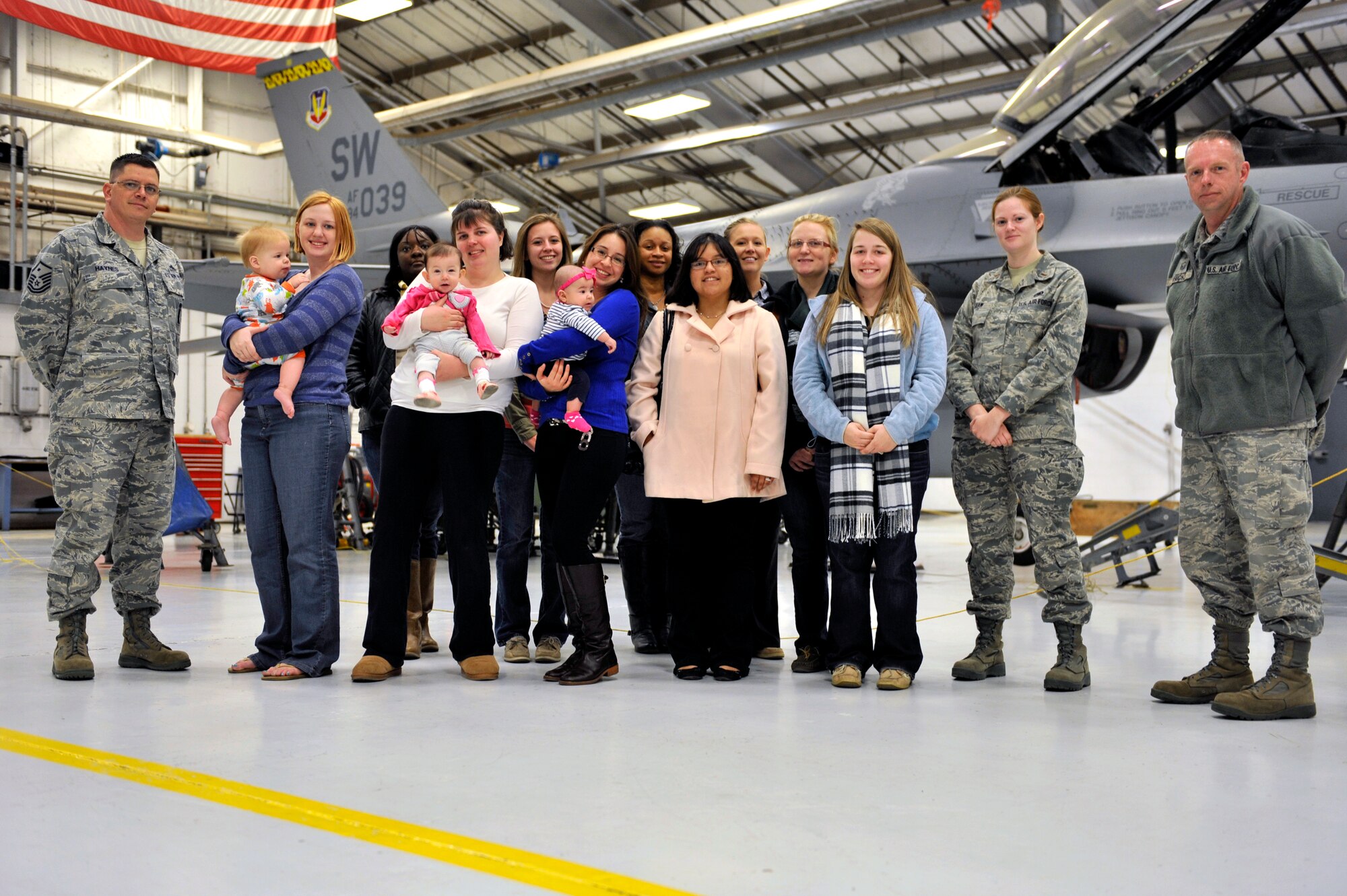 U.S. Air Force Master Sgt. David Haynes, first sergeant, 2nd Lt. Stephanie Shaw, accessories officer in charge, Master Sgt. Craig Hicks, aircraft fuel systems assistant section chief, and spouses, all from the 20th Component Maintenance Squadron, stand next to an F-16 Fighting Falcon, Shaw Air Force Base, S.C., March 22, 2013. Spouses from the 20th CMS visited the fuels shop during a tour of the squadron to gain a better understanding of the Air Force mission. (U.S. Air Force photo by Senior Airman Amber E. N. Jacobs/Released)



