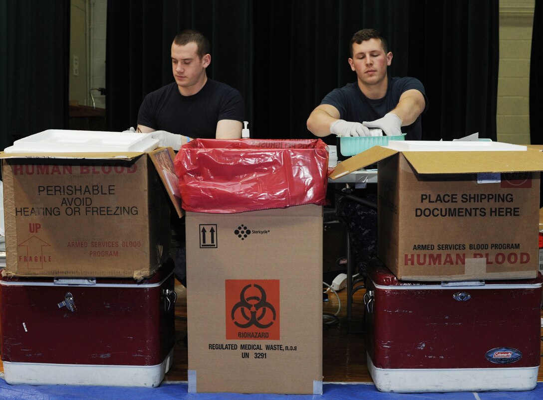 Members of the Armed Services Blood Program collect donations at the blood drive dedicated to the memory of Senior Airman John E. King II at the Joint Base Andrews Theater on March 22, 2013. The ASBP is a joint operation among the military services and many components work together to collect, process, store, distribute and transfuse blood. (U.S. Air Force photo/Airman 1st Class Nesha Humes)