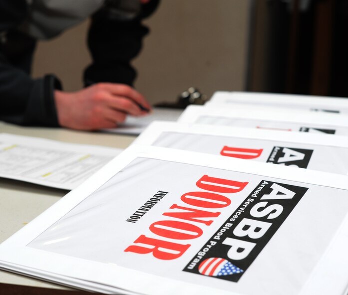 Volunteers sign in during a blood drive dedicated to the memory of Senior Airman John E. King II at the Joint Base Andrews Theater on March 22, 2013.  Members of the Armed Services Blood Program collected the donations at the drive. The ASBP is a joint operation among the military services and many components work together to collect, process, store, distribute and transfuse blood. (U.S. Air Force photo/Airman 1st Class Nesha Humes)