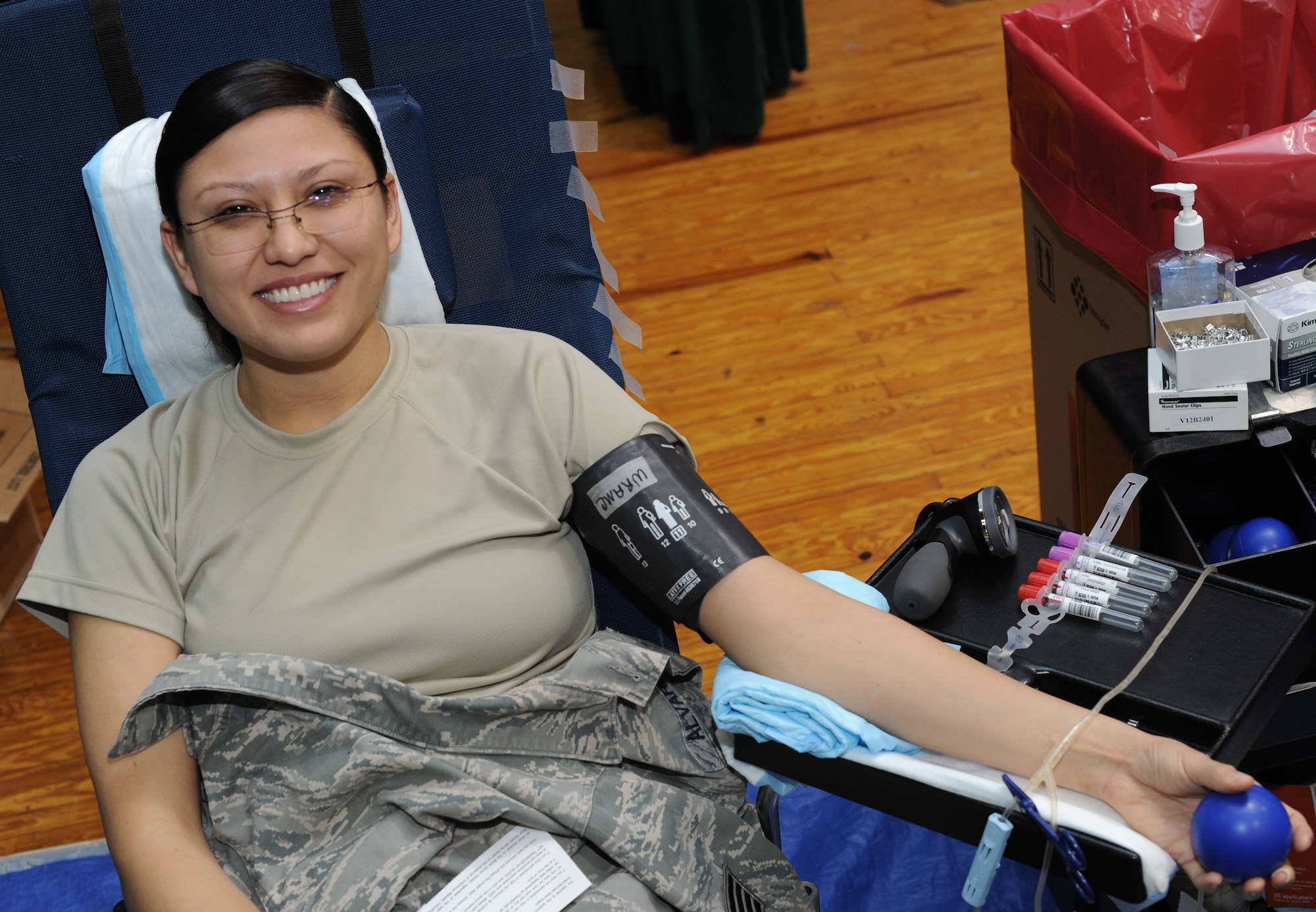Staff Sgt. Brittinie Alvarez, 11th Wing Commander’s Action Group member, donates a pint of blood during a drive dedicated to the memory of Senior Airman John E. King II at the Joint Base Andrews Theater on March 22, 2013. More than 75 service members donated blood to be used at Malcolm Grow Medical Center on Joint Base Andrews and several other treatment facilities in the National Capital Region. (U.S. Air Force photo/Airman 1st Class Nesha Humes)