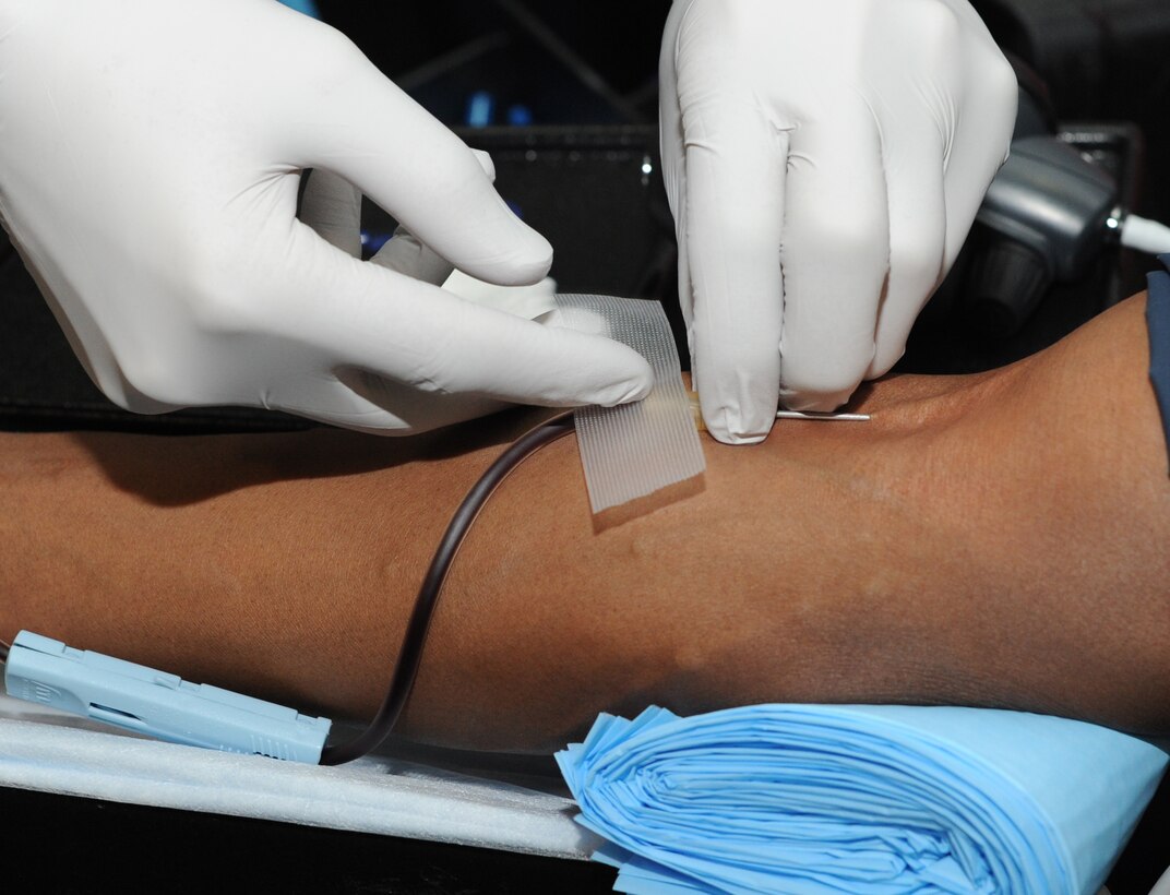 Senior Airmen Sherrick Edwards, 11th Security Forces Squadron patrolman, donates a pint of blood during a drive dedicated to the memory of Senior Airman John E. King II at the Joint Base Andrews Theater on March 22, 2013. The blood donated will be used at local treatment facilities and to support service members serving overseas. (U.S. Air Force photo/Airman 1st Class Nesha Humes)