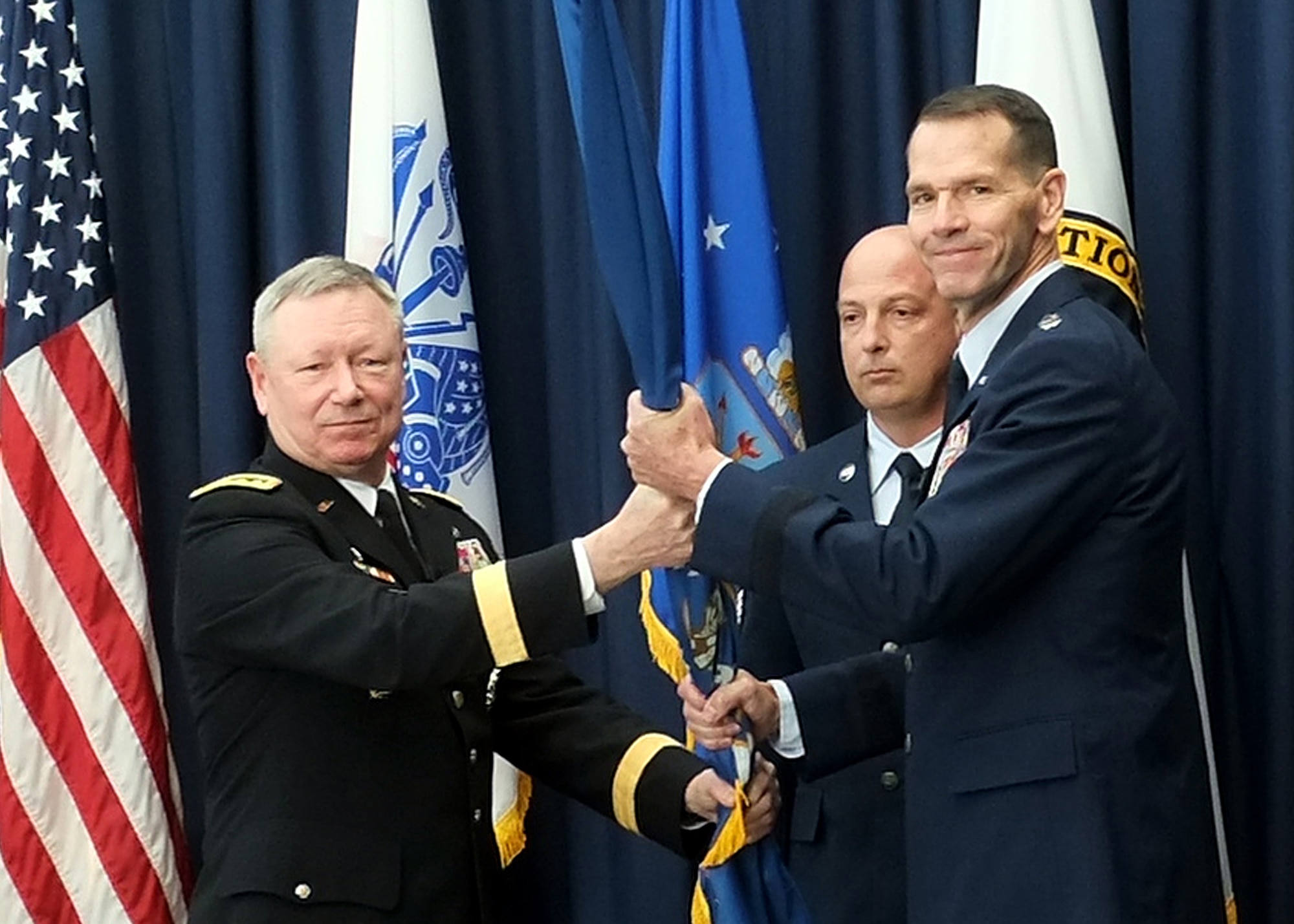 Lt. Gen. Stanley “Sid” Clarke III, right, the director of the Air National Guard, receives the organizational colors of the Air National Guard from Army Gen. Frank Grass, chief, National Guard Bureau, during a ceremony at the Air National Guard Readiness Center at Joint Base Andrews, Md., where Clarke assumed the responsibilities of his current position, Friday, March 22, 2013. Clarke takes over the duties of director from Air Force Lt. Gen. Harry "Bud" Wyatt, who recently retired. (U.S. Army photo by Sgt. 1st Class Jon Soucy)