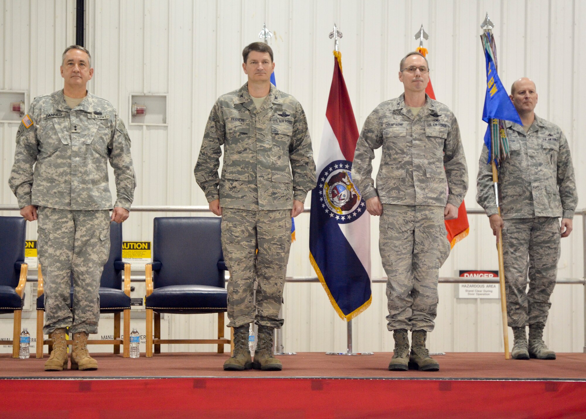 Missouri National Guard adjutant general, Maj. Gen. Stephen Danner, incoming 131st Bomb Wing commander, Col. Mike Francis, Missouri National Guard assistant adjutant general-air, Col. Greg Champagne, and 131st Bomb Wing Command Chief Master Sgt. Rich Pingleton stand at attention while the order is published at the change of command ceremony at Whiteman AFB., March 3.  (National Guard Photo by Staff Sgt. Sean Navarro) 