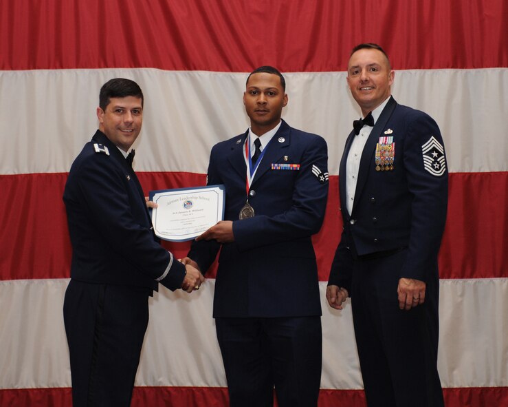 Senior Airman Jovonte Williams, 2nd Medical Support Squadron, receives an Airman Leadership School Graduation certificate from Col. Andrew Gebara, 2nd Bomb Wing commander, on Barksdale Air Force Base, La., March 21. (U.S. Air Force photo)