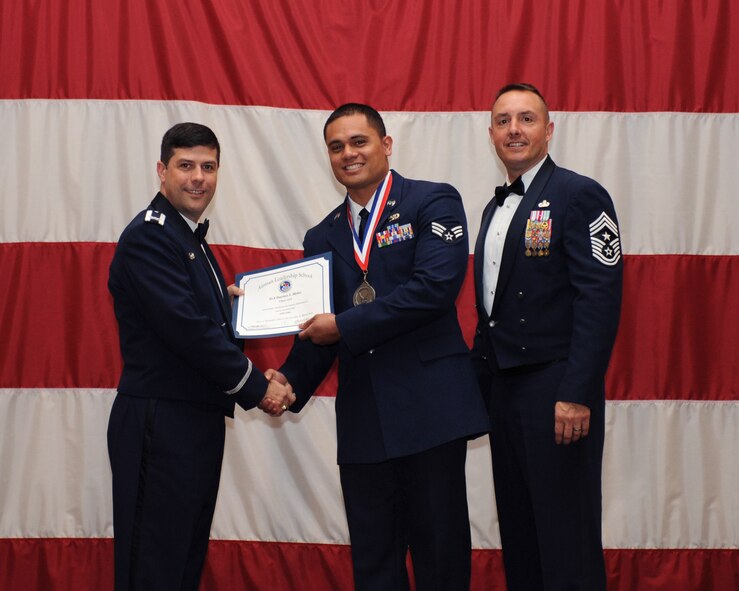Senior Airman Dayton Moku, 2nd Logistics Readiness Squadron, receives an Airman Leadership School Graduation certificate from Col. Andrew Gebara, 2nd Bomb Wing commander, on Barksdale Air Force Base, La., March 21. (U.S. Air Force photo)
