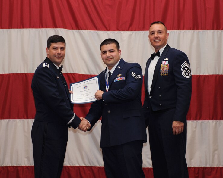 Senior Airman Jordan Mathis, 2nd Security Forces Squadron, receives an Airman Leadership School Graduation certificate from Col. Andrew Gebara, 2nd Bomb Wing commander, on Barksdale Air Force Base, La., March 21. (U.S. Air Force photo)