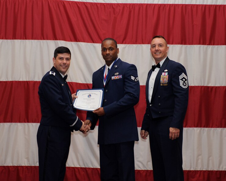 Senior Airman Princeton Drake, 2nd Aircraft Maintenance Squadron, receives an Airman Leadership School Graduation certificate from Col. Andrew Gebara, 2nd Bomb Wing commander, on Barksdale Air Force Base, La., March 21. (U.S. Air Force photo)