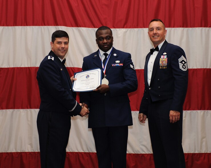 Senior Airman Guy-marcus Atidepe, 2nd Logistics Readiness Squadron, receives an Airman Leadership School Graduation certificate from Col. Andrew Gebara, 2nd Bomb Wing commander, on Barksdale Air Force Base, La., March 21. (U.S. Air Force photo)