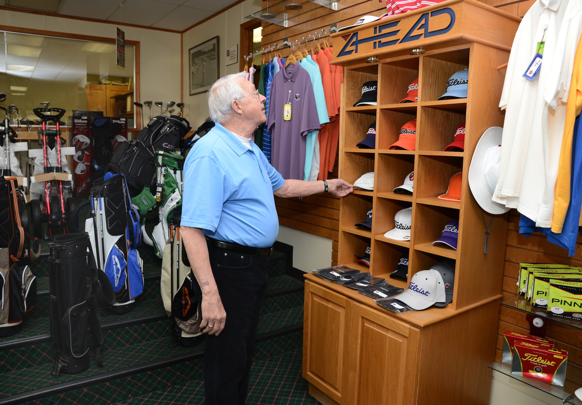 Pro Shop attendant Don Nicholson makes sure the merchandise is properly priced and arranged neatly to appeal to customers. (Air Force photo by Kelly White)