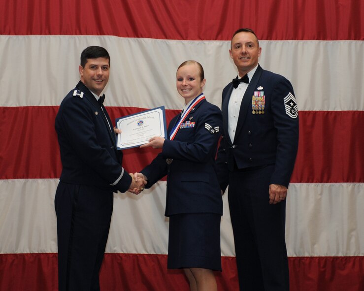 Senior Airman Sarah Spare, 2nd Communications Squadron, receives an Airman Leadership School Graduation certificate from Col. Andrew Gebara, 2nd Bomb Wing commander, on Barksdale Air Force Base, La., March 21. (U.S. Air Force photo)