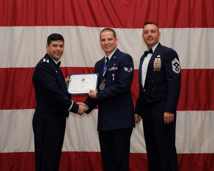 Senior Airman Andrew Shaffer, 2nd Maintenance Operations Squadron, receives an Airman Leadership School Graduation certificate from Col. Andrew Gebara, 2nd Bomb Wing commander, on Barksdale Air Force Base, La., March 21. (U.S. Air Force photo)