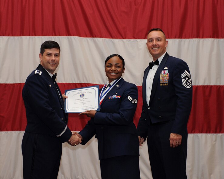 Senior Airman Sabrina Mahone, 2nd Dental Squadron, receives an Airman Leadership School Graduation certificate from Col. Andrew Gebara, 2nd Bomb Wing commander, on Barksdale Air Force Base, La., March 21. (U.S. Air Force photo)