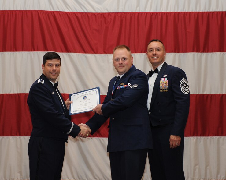 Senior Airman Dusty Hines, 2nd Aircraft Maintenance Squadron, receives an Airman Leadership School Graduation certificate from Col. Andrew Gebara, 2nd Bomb Wing commander, on Barksdale Air Force Base, La., March 21. (U.S. Air Force photo)