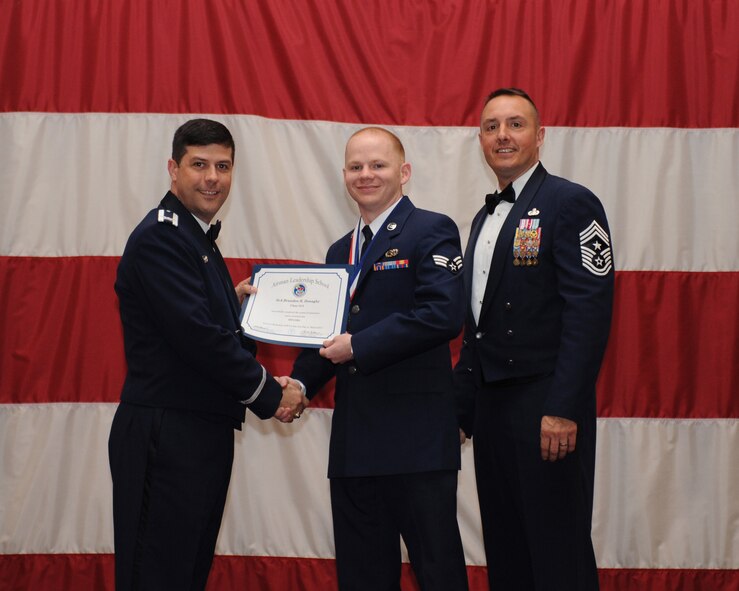 Senior Airman Brandon Donaghy, 2nd Maintenance Squadron, receives an Airman Leadership School Graduation certificate from Col. Andrew Gebara, 2nd Bomb Wing commander, on Barksdale Air Force Base, La., March 21. (U.S. Air Force photo)