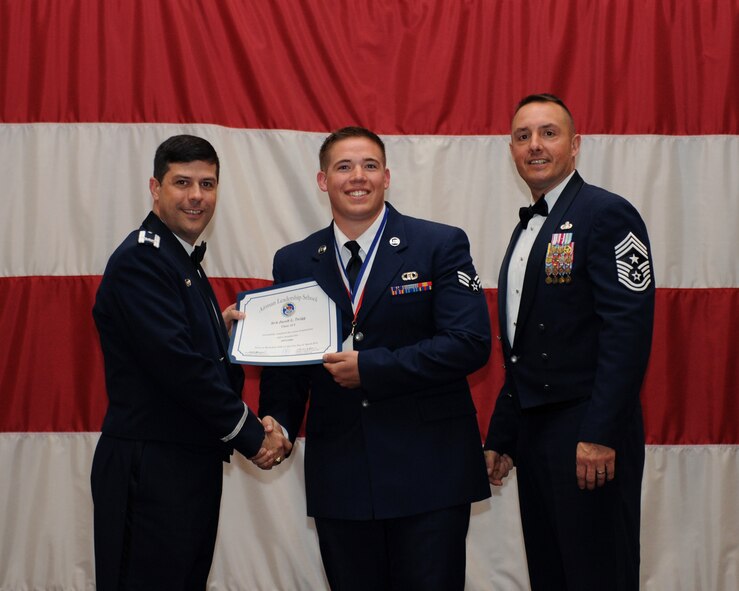 Senior Airman Jacob Twigg, 2nd Operations Support Squadron, receives an Airman Leadership School Graduation certificate from Col. Andrew Gebara, 2nd Bomb Wing commander, on Barksdale Air Force Base, La., March 21. (U.S. Air Force photo)