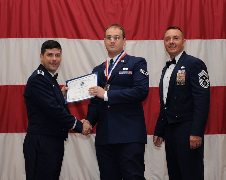 Senior Airman Matthew Smith, 2nd Aircraft Maintenance Squadron, receives an Airman Leadership School Graduation certificate from Col. Andrew Gebara, 2nd Bomb Wing commander, on Barksdale Air Force Base, La., March 21. (U.S. Air Force photo)