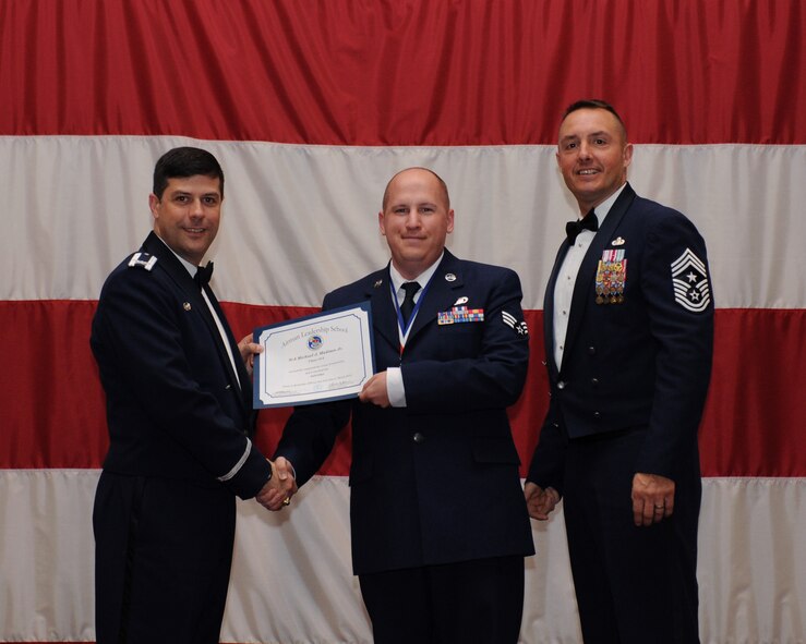 Senior Airman Michael Madison, 2nd Contracting Squadron, receives an Airman Leadership School Graduation certificate from Col. Andrew Gebara, 2nd Bomb Wing commander, on Barksdale Air Force Base, La., March 21. (U.S. Air Force photo)