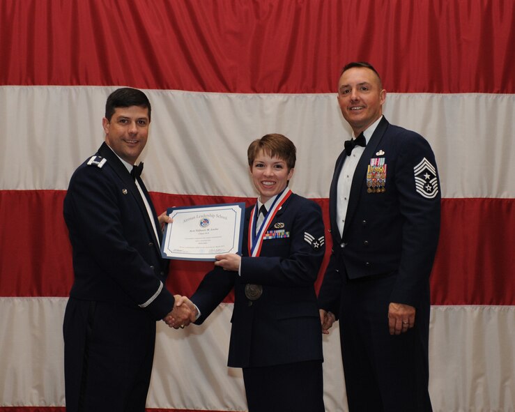 Senior Airman Tiffanie Locke, 2nd Munitions Squadron, receives an Airman Leadership School Graduation certificate from Col. Andrew Gebara, 2nd Bomb Wing commander, on Barksdale Air Force Base, La., March 21. (U.S. Air Force photo)