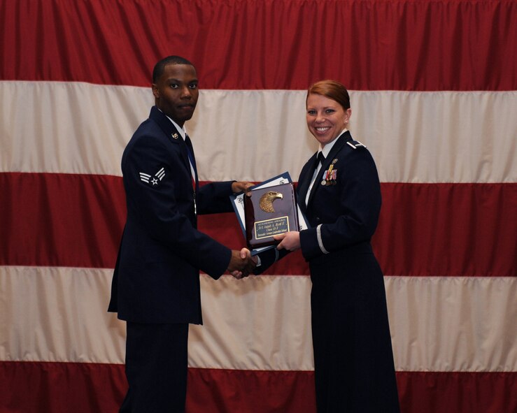 Senior Airman Jaquit Bryd, 2nd Maintenance Squadron, receives the Academic Award Plaque from 1st Lt. Carissa Hoosline, 2nd Force Support Squadron, during the Airman Leadership School Class 13-3 Graduation on Barksdale Air Force Base, La., March 21. (U.S. Air Force photo)