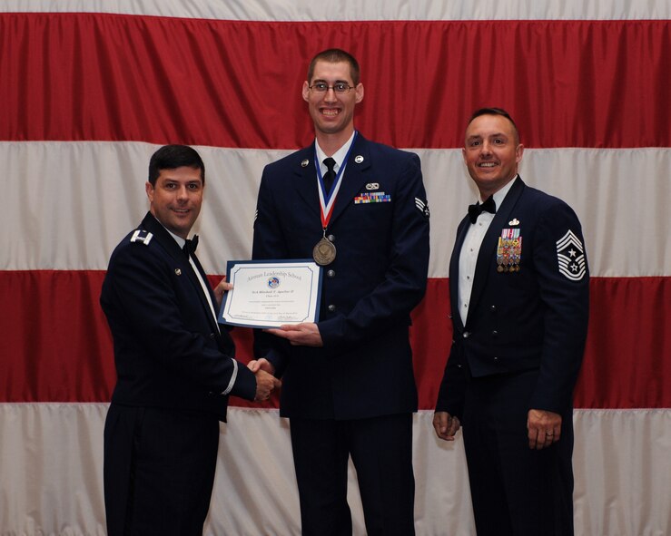 Senior Airman Mitchell Aguilar, 2nd Aircraft Maintenance Squadron, receives an Airman Leadership School Graduation certificate from Col. Andrew Gebara, 2nd Bomb Wing commander, on Barksdale Air Force Base, La., March 21. (U.S. Air Force photo)