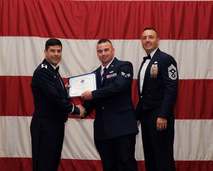 Senior Airman Elliot Meyer, 2nd Civil Engineer Squadron, receives an Airman Leadership School Graduation certificate from Col. Andrew Gebara, 2nd Bomb Wing commander, on Barksdale Air Force Base, La., March 21. (U.S. Air Force photo)