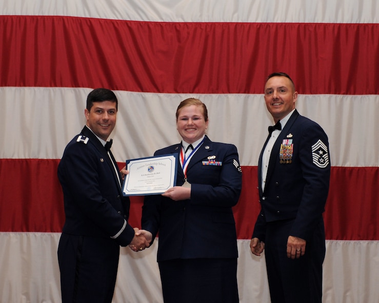 Senior Airman Katherine Holt, 2nd Bomb Wing Public Affairs, receives an Airman Leadership School Graduation certificate from Col. Andrew Gebara, 2nd Bomb Wing commander, on Barksdale Air Force Base, La., March 21. (U.S. Air Force photo)