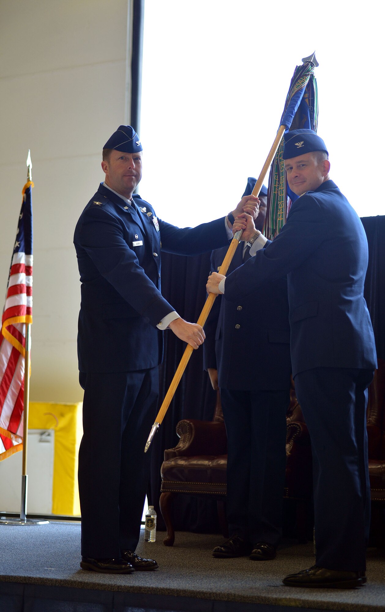 Col. Wyn Elder, 62nd Airlift Wing commander, presents the 62nd Operations Group guidon to Col. Andrew Hird, incoming 62nd OG commander during the 62nd OG Change of Command ceremony March. 21, 2013, at Joint Base Lewis-McChord, Wash. The passing of the guidon is a military tradition signifying the official assumption of command. (U.S. Air Force photo/Airman 1st Class Jacob Jimenez)