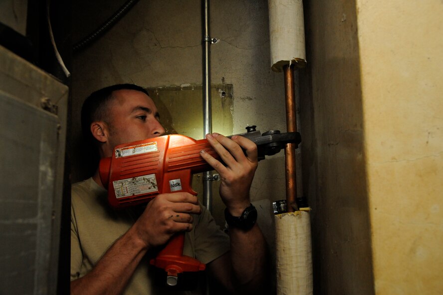 Staff Sgt. William Stell, 2nd Civil Engineer Squadron Water and Fuel Systems Maintenance, uses a pro-press on Barksdale Air Force Base, La., March 22. The pro-press saves time by squeezing a pipe shut instead of soldering which may take longer or be more difficult when in confined spaces. (U.S. Air Force photo/Airman 1st Class Andrew Moua)