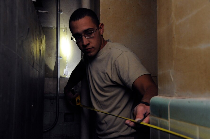 Senior Airman Michael Bustamante, 2nd Civil Engineer Squadron Water and Fuel Systems Maintenance, measures a wall to install piping for a waterline on Barksdale Air Force Base, La., March 22. The water line was installed to a mechanical room which lacked plumbing. (U.S. Air Force photo/Airman 1st Class Andrew Moua)