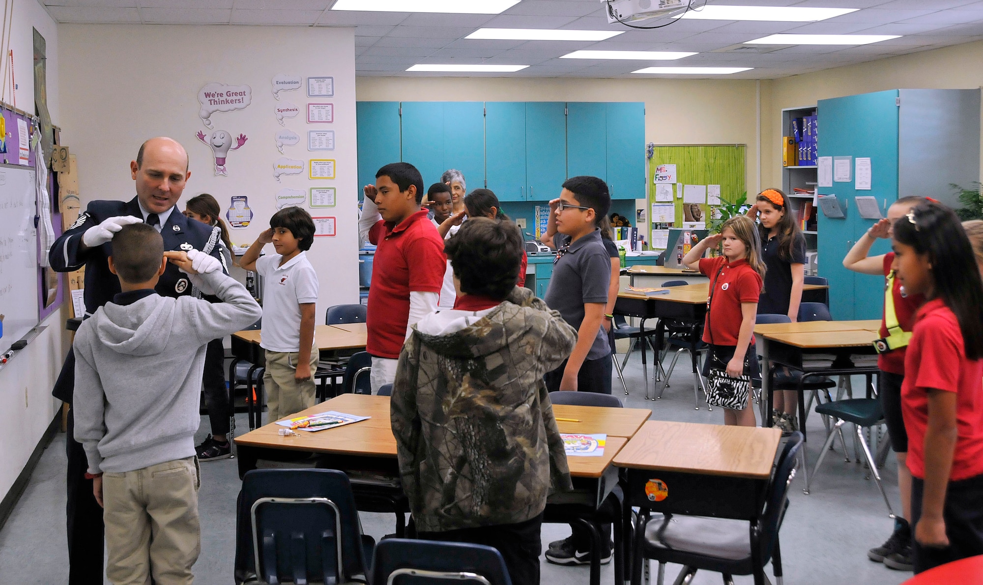Master Sgt. Francisco Navarro, Homestead Air Reserve Base honor guard chief, teaches fourth and fifth graders from Redland Elementary School in Homestead, Fla., how to render a salute during the school’s career day March 21. Navarro discussed the finer points of a career in the Air Force during his visit. (U.S. Air Force photo/Tim Norton)