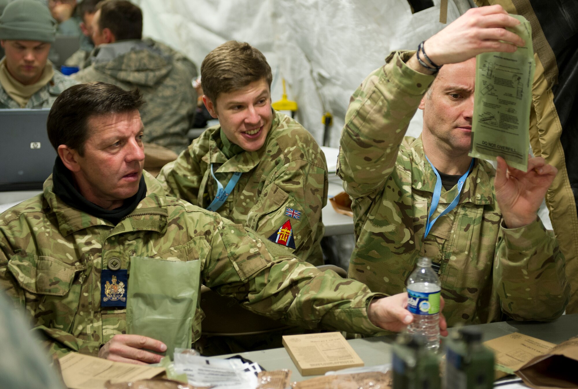 JOINT BASE MCGUIRE-DIX-LAKEHURST, N.J -- Members of the Royal Air Force eat Meals Ready to Eat (MRE) here during the Eagle Flag 13-1exercise here March 14, 2013.  The Joint Task Force-Port Opening was tested on their ability to quickly establish operations, provide their own security, track cargo and personnel and move supplies from the planes to customers quickly and efficiently. (U.S. Air Force photo by Staff Sgt. Gustavo Gonzalez)