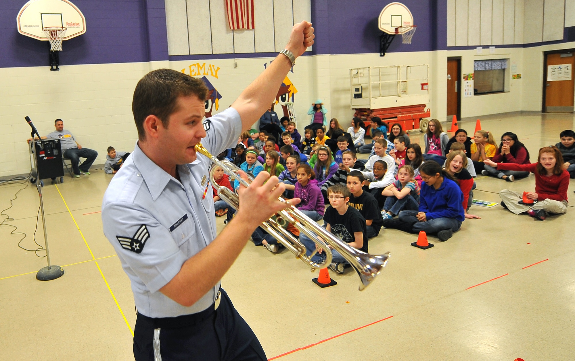 U.S. Air Force Senior Airman Timothy Schleinat, a trumpet player with the Heartland of America Band, gives an energetic performance for the students of LeMay Elementary School on March 21, Offutt Air Force Base, Neb.  Several area schools have been visited by the Offutt Brass ensemble over the past several days.  The ensemble introduced the children to several classic composers from around the world as well as injecting theme music from both Star Wars and Spiderman.  (U.S. Air Force photo by Josh Plueger/Released).