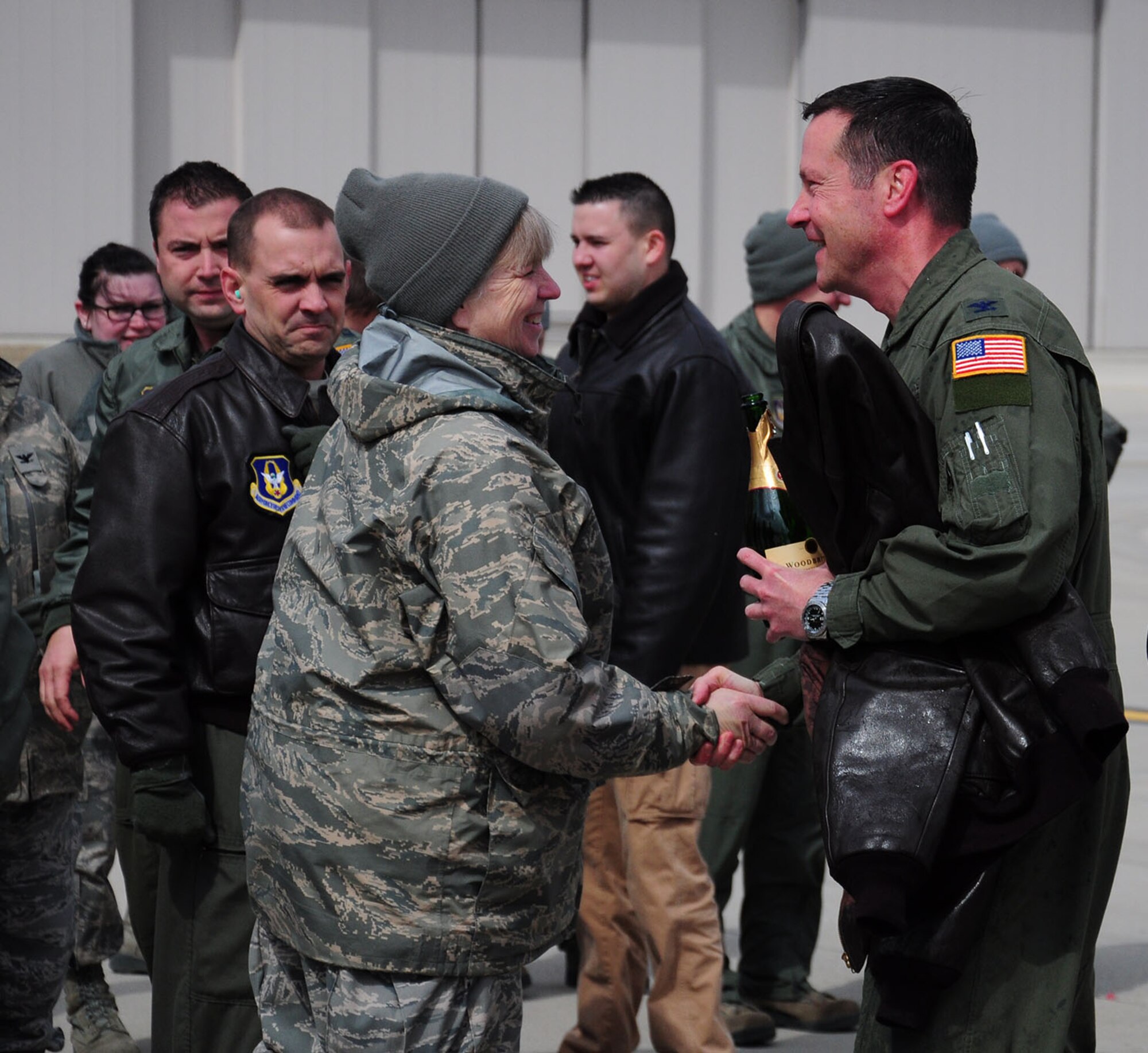 WRIGHT-PATTERSON AIR FORCE BASE, Ohio – Lt. Col. Catherine Seibert, 445th Operations Group Stan/Eval examiner flight nurse, congratulates Col. Kenneth Council, 445th Operations Group commander, as he celebrates his final C-17 flight, or “fini flight,” here March 21. A fini flight is a time-honored military aviation tradition marking the end of a pilot’s or commander’s time upon completion of their final flight. (U.S. Air Force photo/Airman 1st Class Santana Austin)