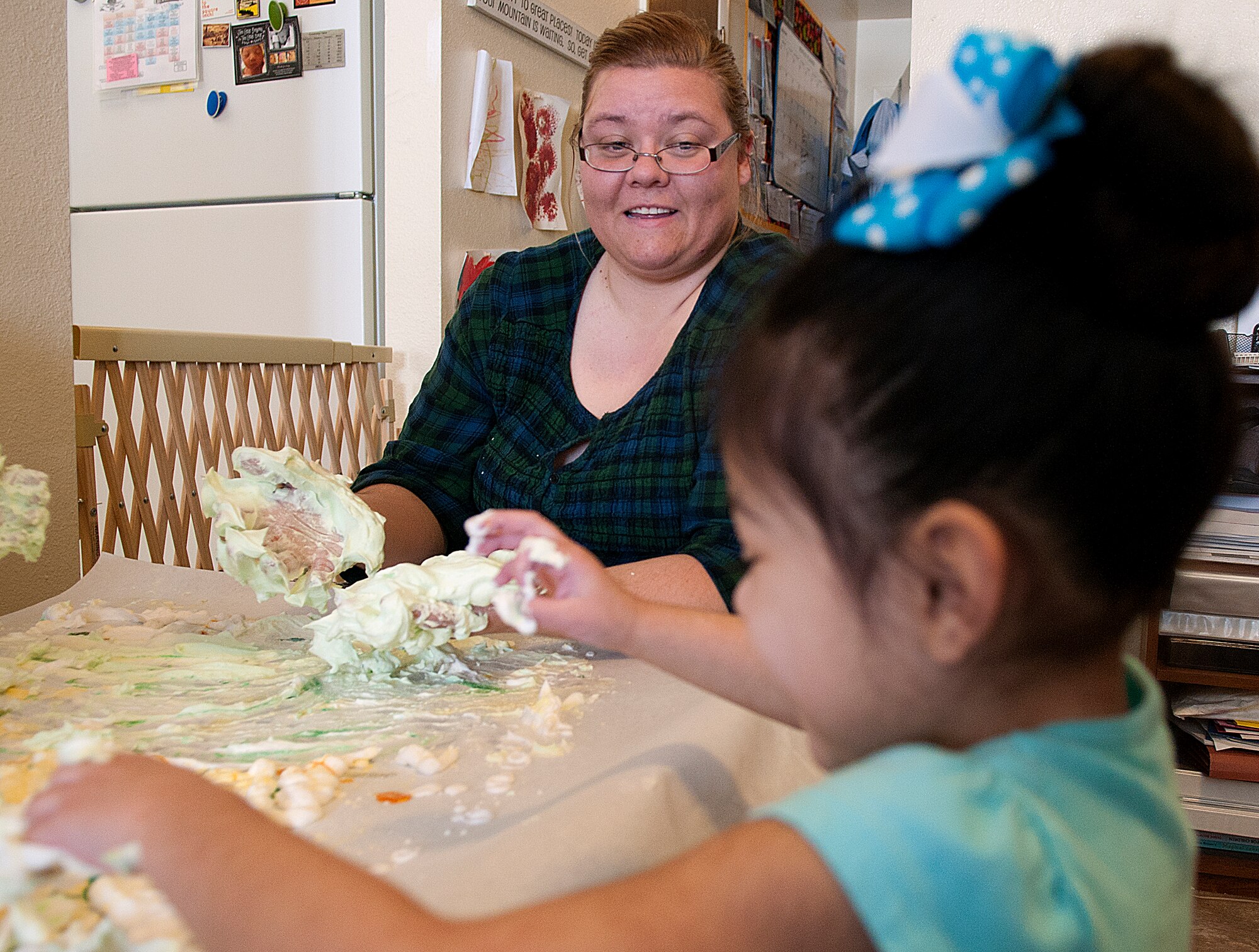 Katherine Lewis works with Kasey Valerio, 4, during a sensory activity in Lewis’s home on F.E. Warren Air Force Base March 12.  Lewis has been named Family Childcare Provider of the Year by the F. E. Warren Family Childcare Panel. (U.S. Air Force photo by R.J. Oriez)