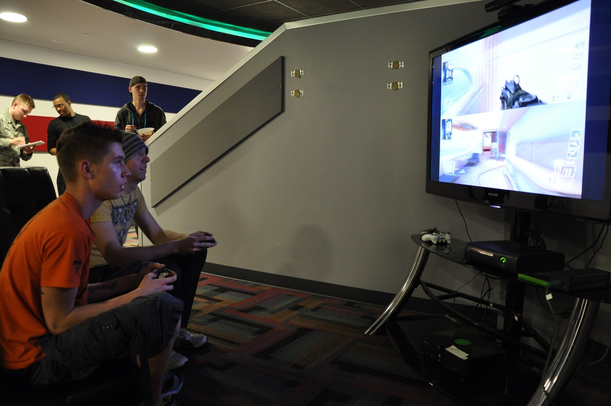 Airman 1st Class James Dean, 90th Maintenance Operations Squadron, and Airman 1st Class Frank Drahos, 90th Logistics Readiness Squadron, participate in a Call of Duty tournament March 14 in the Fall Hall Community Center during a dorm dinner organized by the base chapel with assistance from the Cheyenne Women’s Civic League. Members of Cheyenne’s Women’s Civic League prepared chili and corn bread for dinner. Airmen living in the dorms also played free laser tag and the top three finishers in the Call of Duty tournament received gift cards. (U.S. Air Force photo by Senior Airman Dan Gage)
