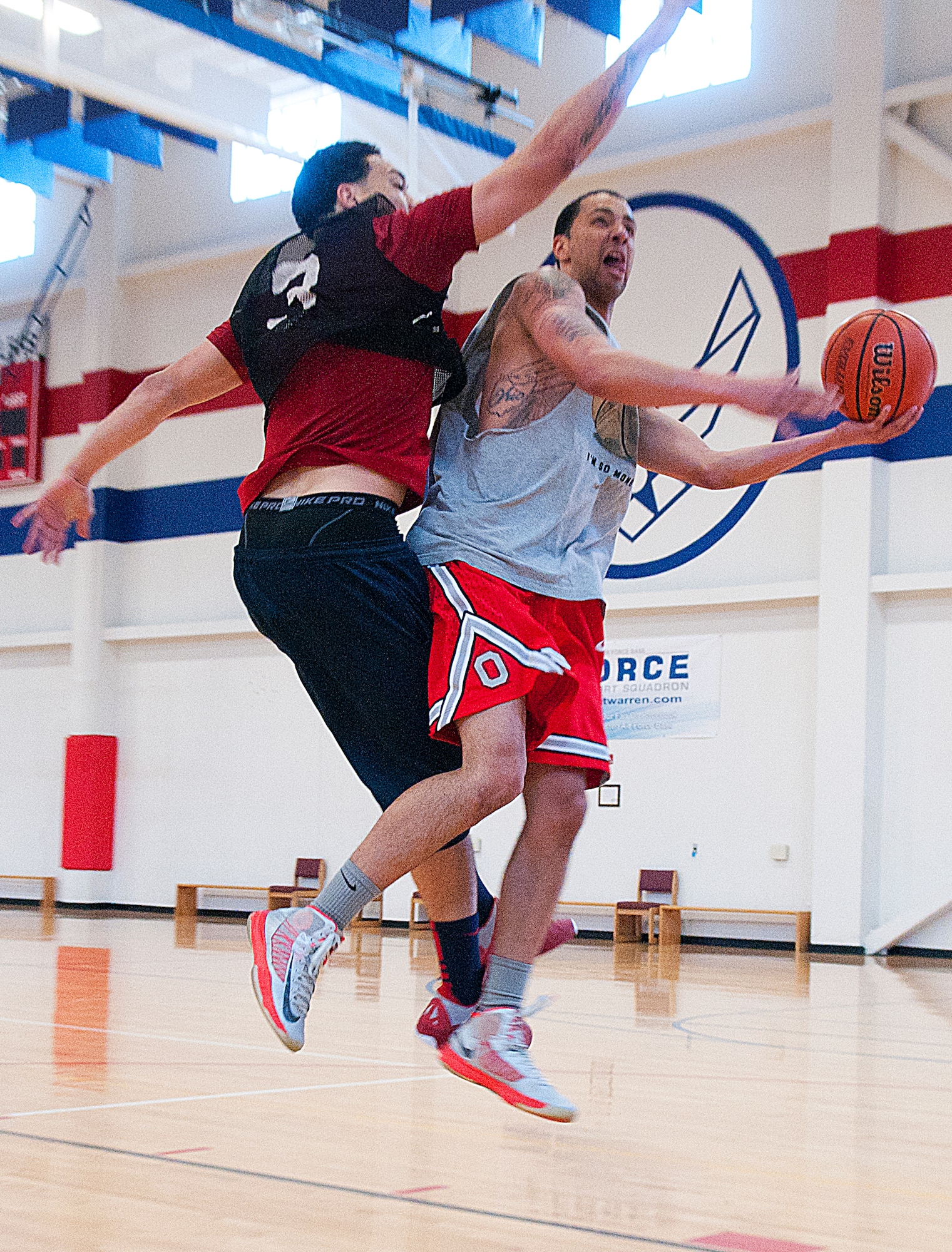 Corey Rucker of team Us goes up for a shot against Uptown’s Larry Boyd in the final game of the fitness center’s 3-on-3 basketball tournament March 16. (U.S. Air Force photo by R.J. Oriez)